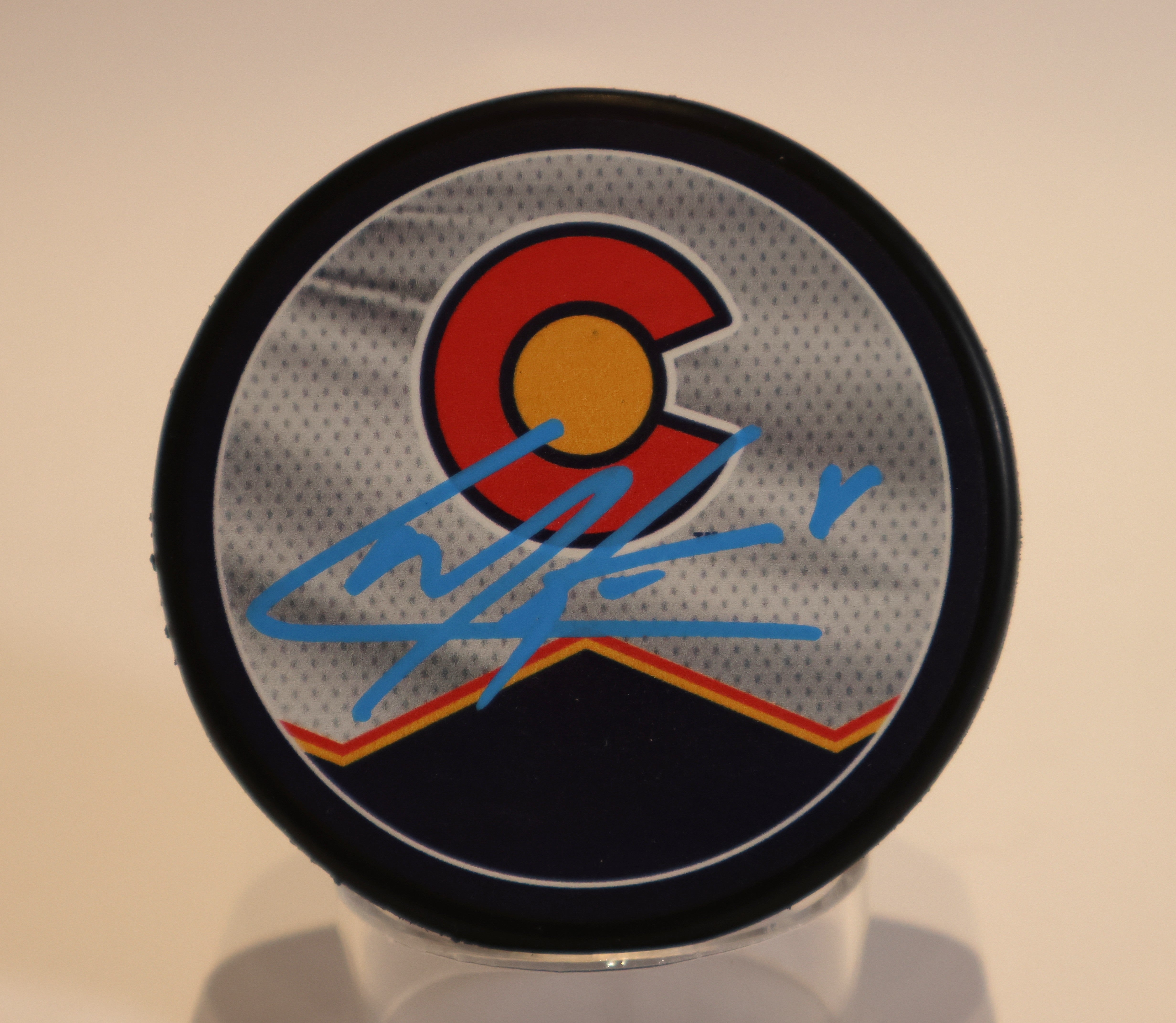 Cale Makar Autographed Puck - Colorado Flag Jersey/Burgandy Av's